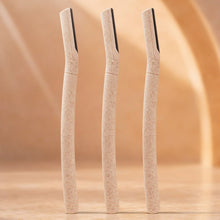 Three beige makeup shape with black bristle tips on a beige background