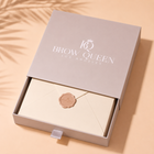 Open box with 'Brow Queen Los Angeles' branding on a beige background