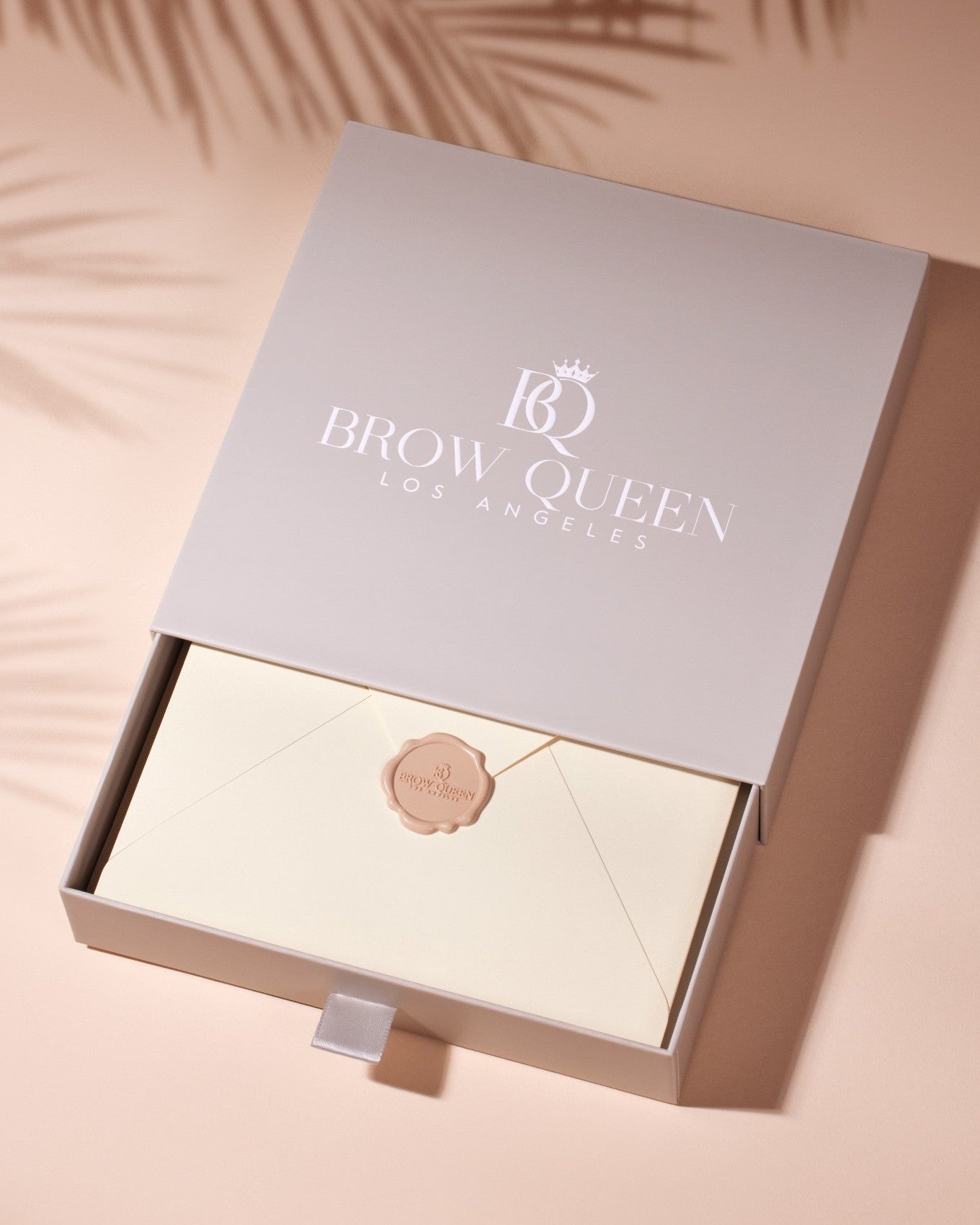Brow Queen packaging with a beige envelope on a peach background