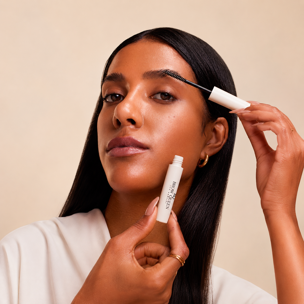 Woman applying gel with a brush against a beige background