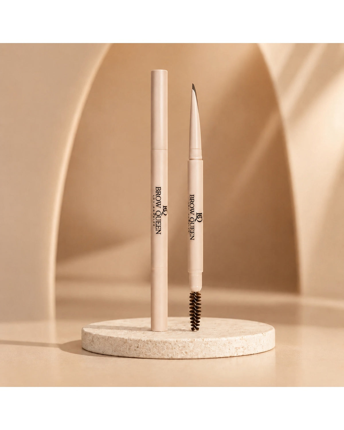 Dual-ended Eyebrow Pencil on a textured pedestal, showing the precision tip and spoolie brush for shaping and filling brows.